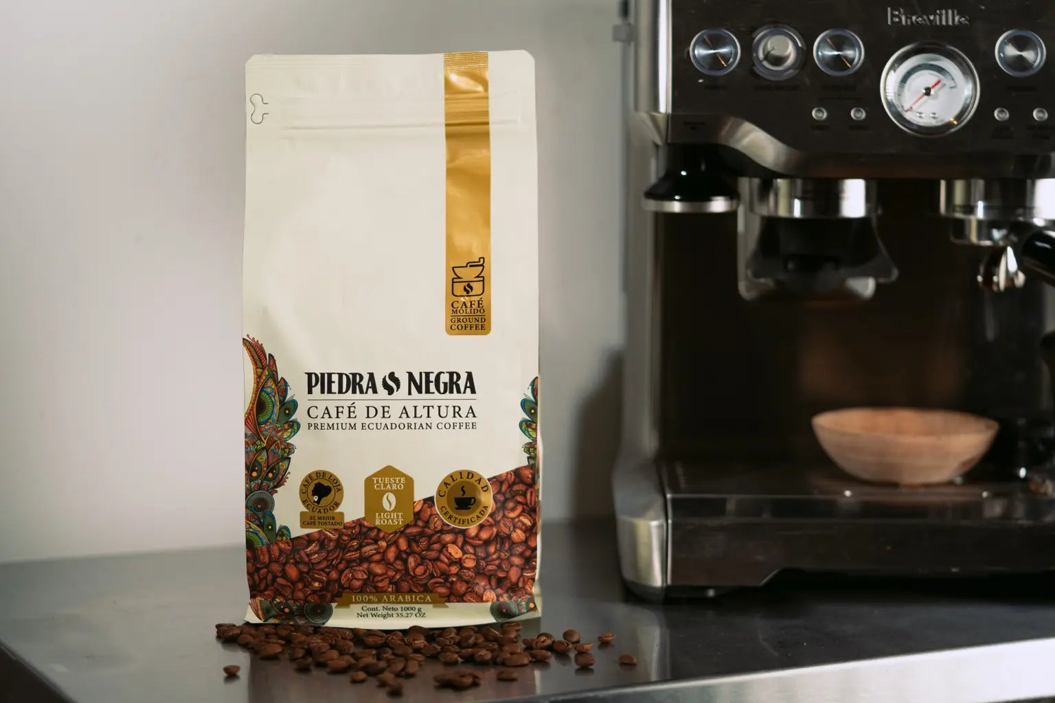 One kilogram Light Roast bag beside an espresso machine