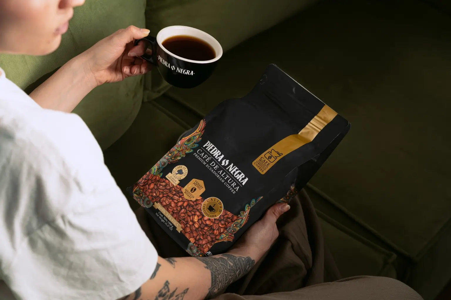Customer enjoying coffee while holding a one kilogram Medium Roast bag